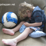 child asleep with soccer ball