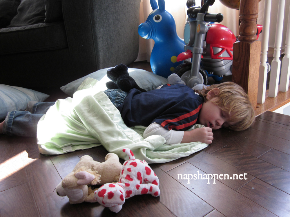 boy asleep with toys